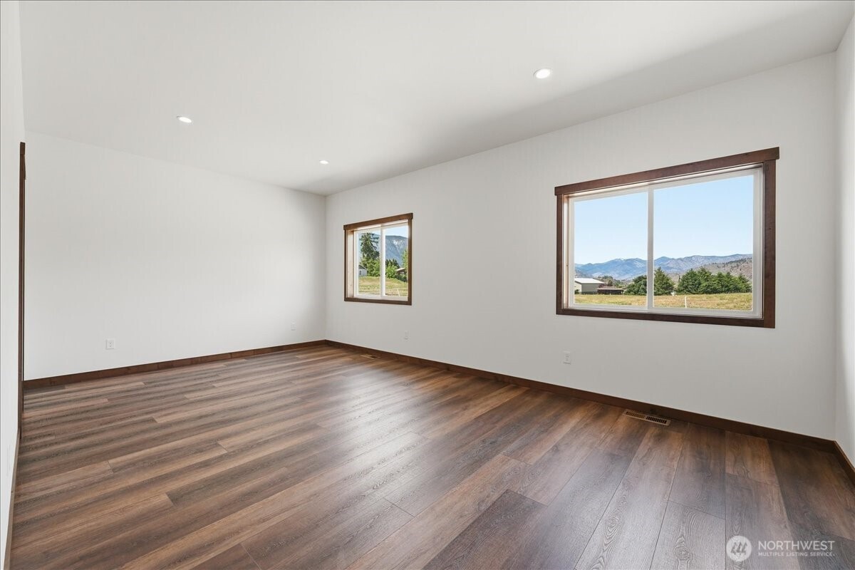 110 Slide View Lane Manson, WA 98831 - Photo 24 of 38 a view of an empty room with wooden floor and a window
