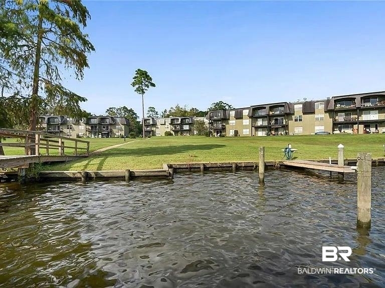 301 Riverbend Drive, Unit 301 Mobile, AL 36605 - Photo 1 of 18 Dock area featuring a yard and a water view