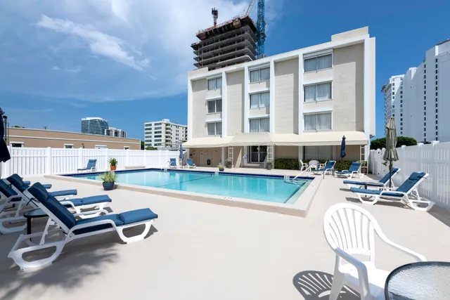 a view of a swimming pool and lounge chairs