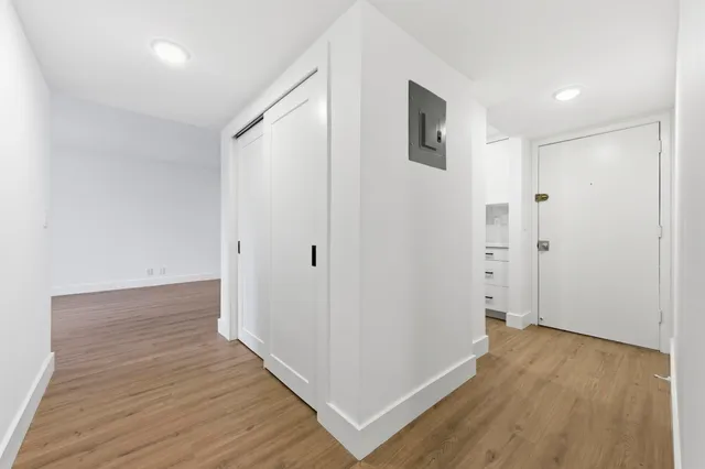 a view of a hallway with wooden floor