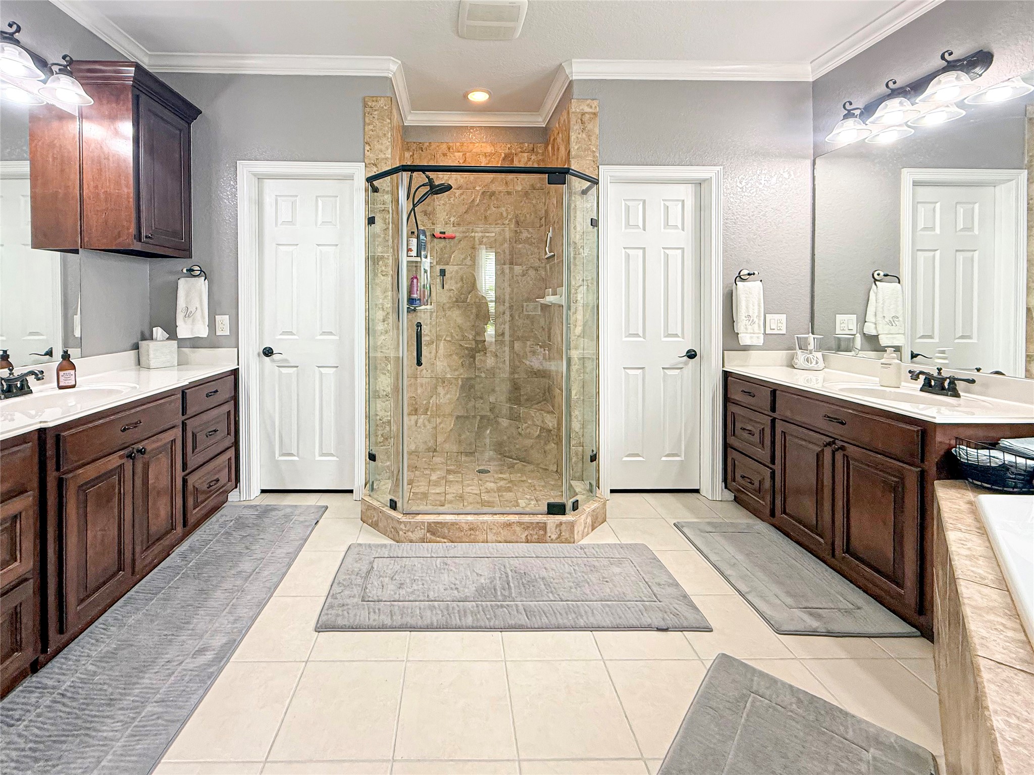 807 Mill Road Angleton, TX 77515 - Photo 24 of 46 Spa-like primary bath features dual vanities, a jetted corner tub, and oversized shower.