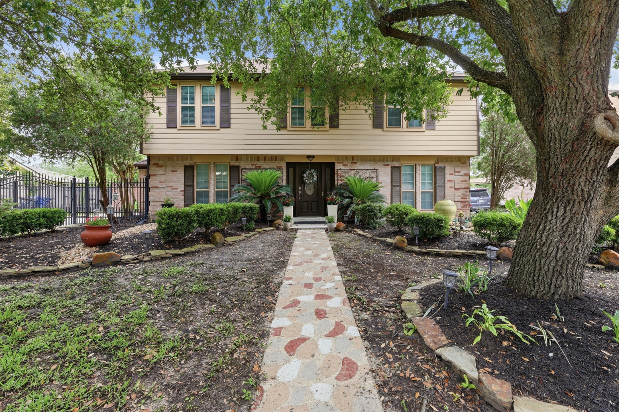 7010 River Mill Drive Spring, TX 77379 - Photo 2 of 29 a front view of a house with garden