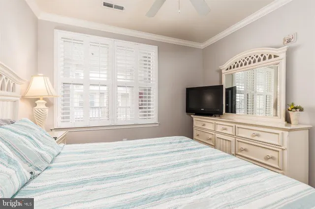 a bedroom with a large bed and a flat screen tv