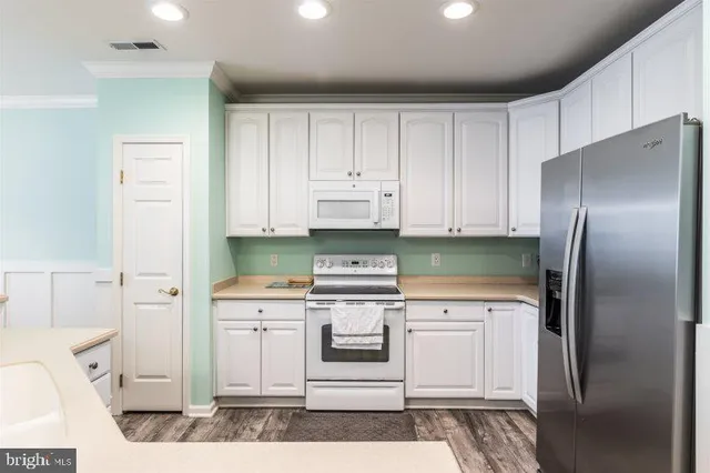 a kitchen with a white cabinets and white appliances