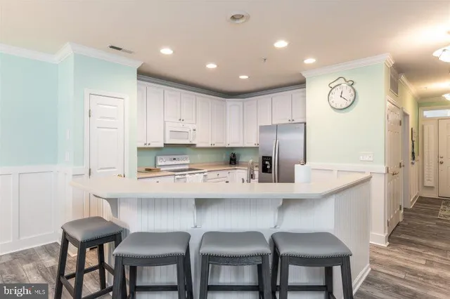 a kitchen with stainless steel appliances a sink and cabinets