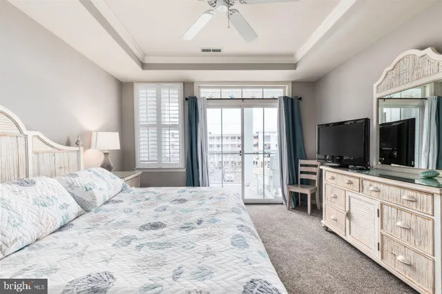 a spacious bedroom with a large bed and a flat screen tv