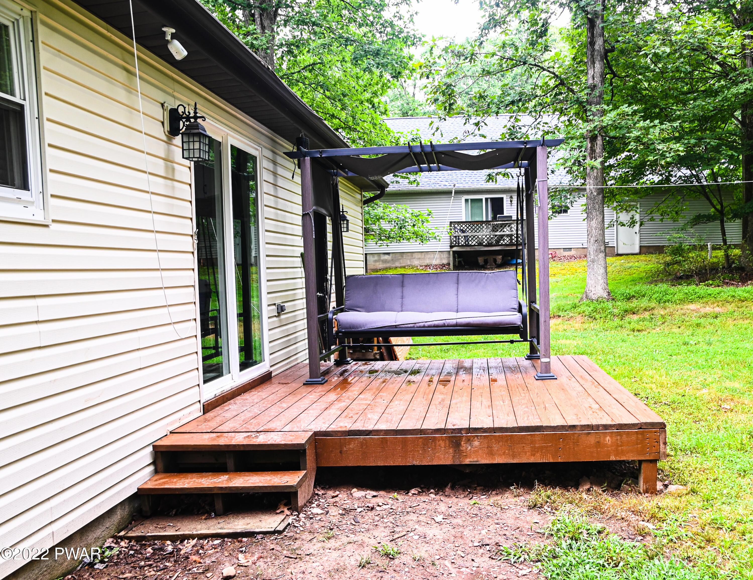 233 Bromley Road Henryville, PA 18332 - Photo 21 of 22 a backyard of a house with yard and outdoor seating