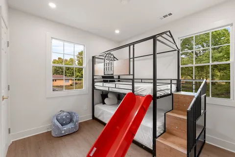 a bedroom with furniture and a large window