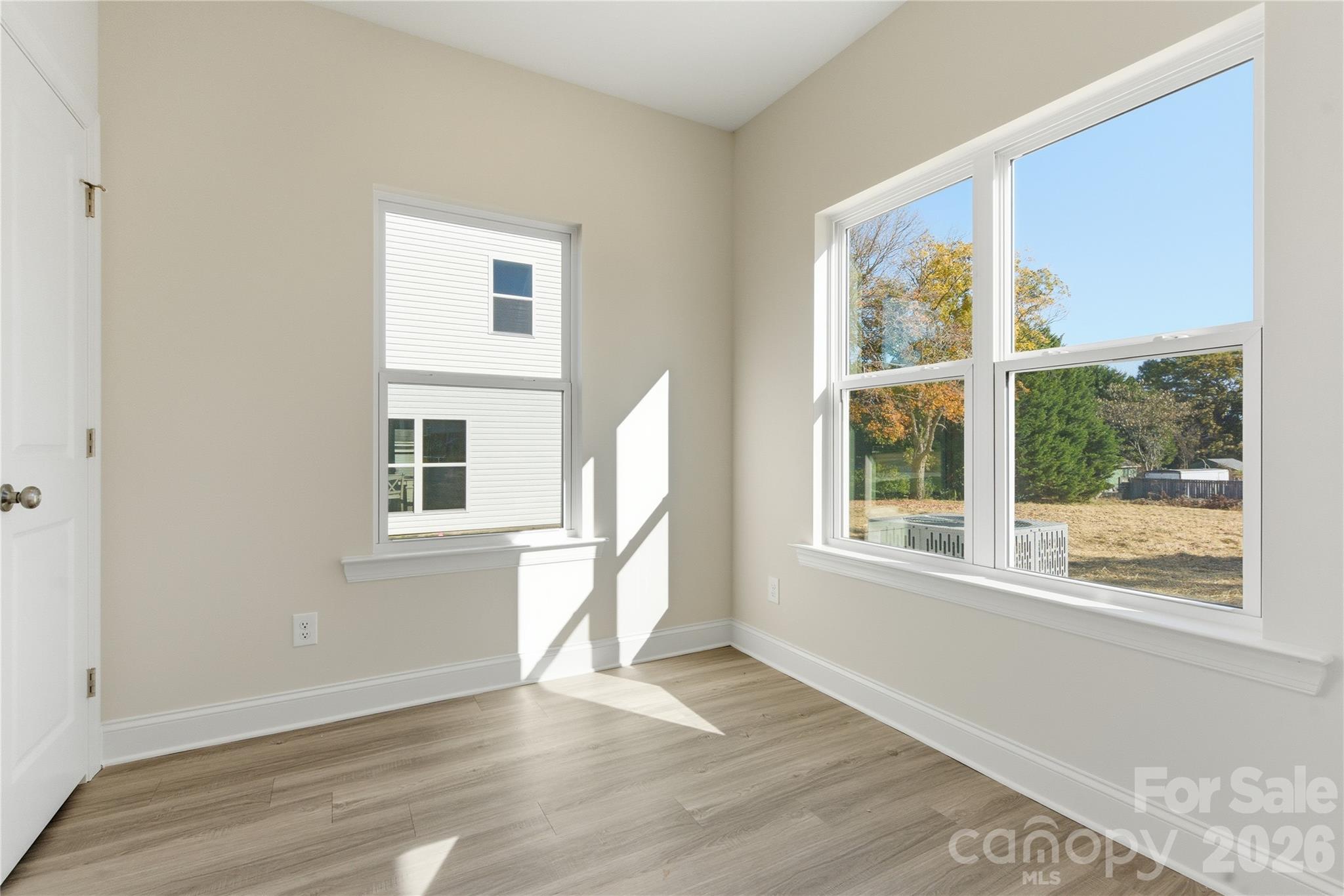 230 1st Street South Fort Mill, SC 29708 - Photo 16 of 22 an empty room with wooden floor and windows