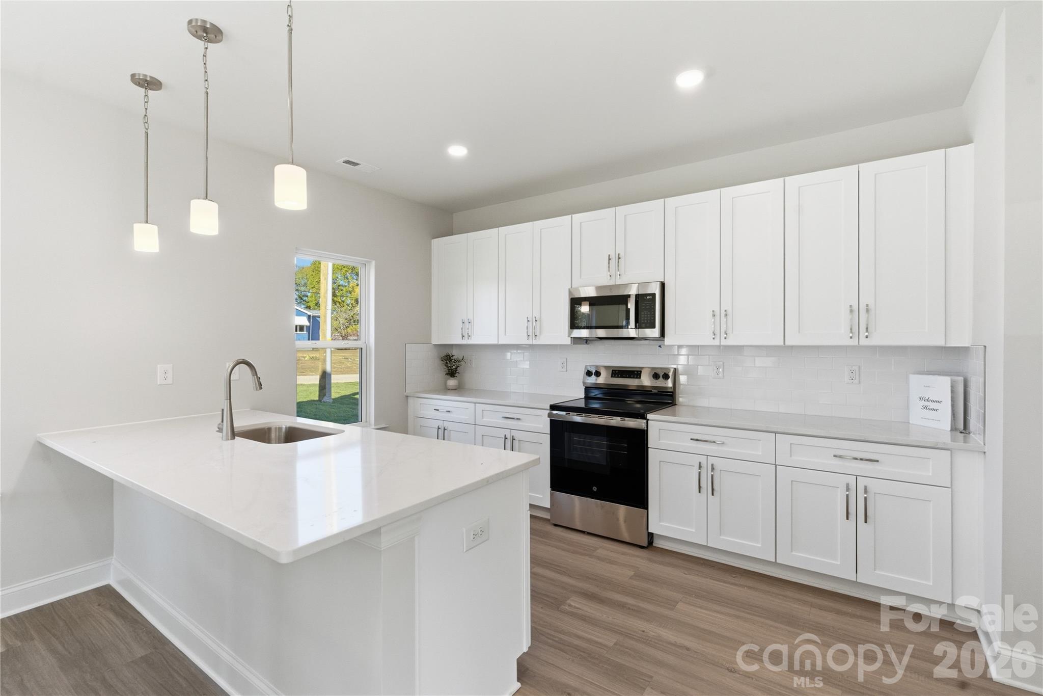 230 1st Street South Fort Mill, SC 29708 - Photo 6 of 22 a kitchen with stainless steel appliances kitchen island granite countertop a sink a stove and cabinets
