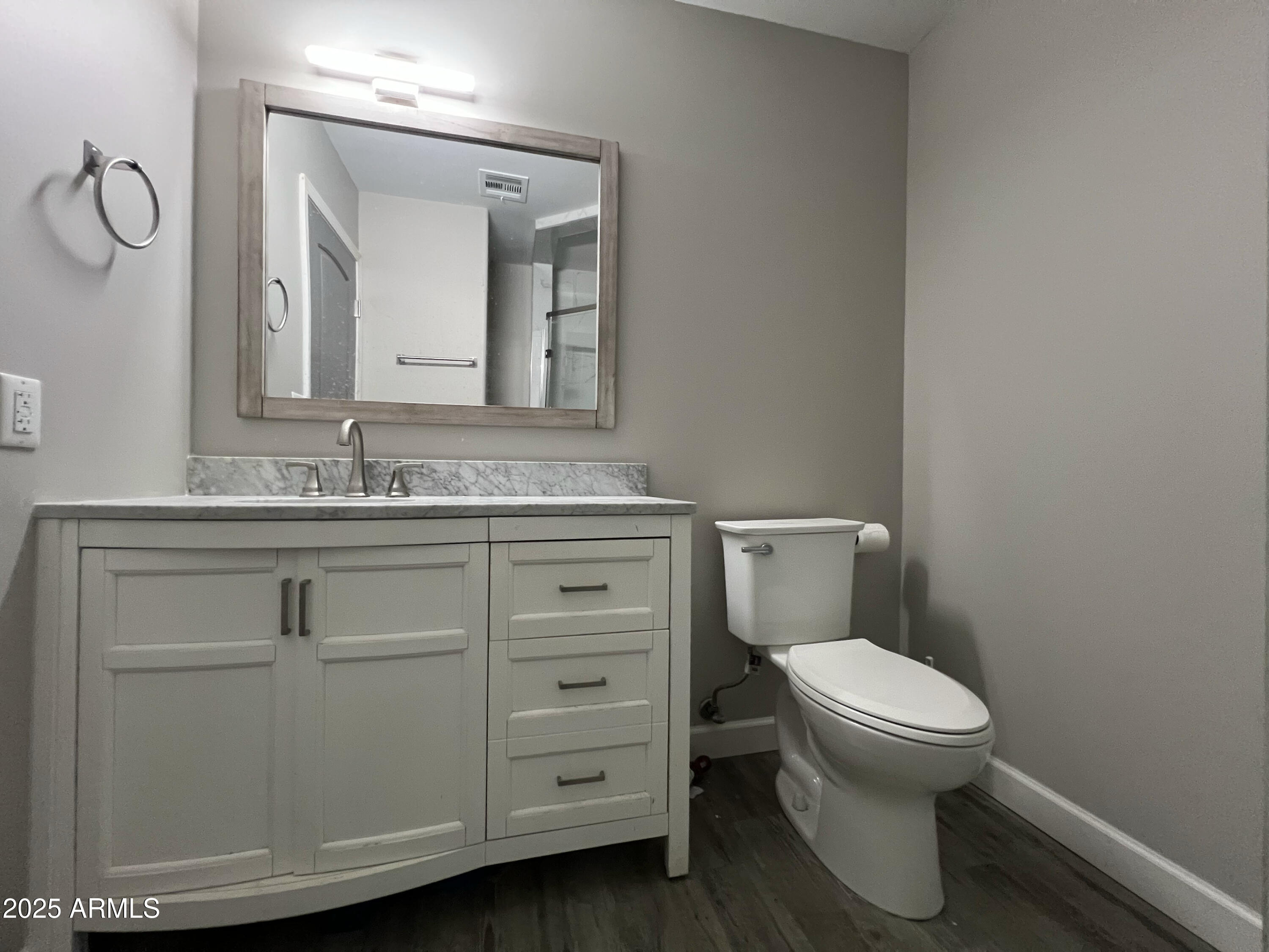 8201 South 26th Street Phoenix, AZ 85042 - Photo 15 of 42 a bathroom with a toilet sink and mirror