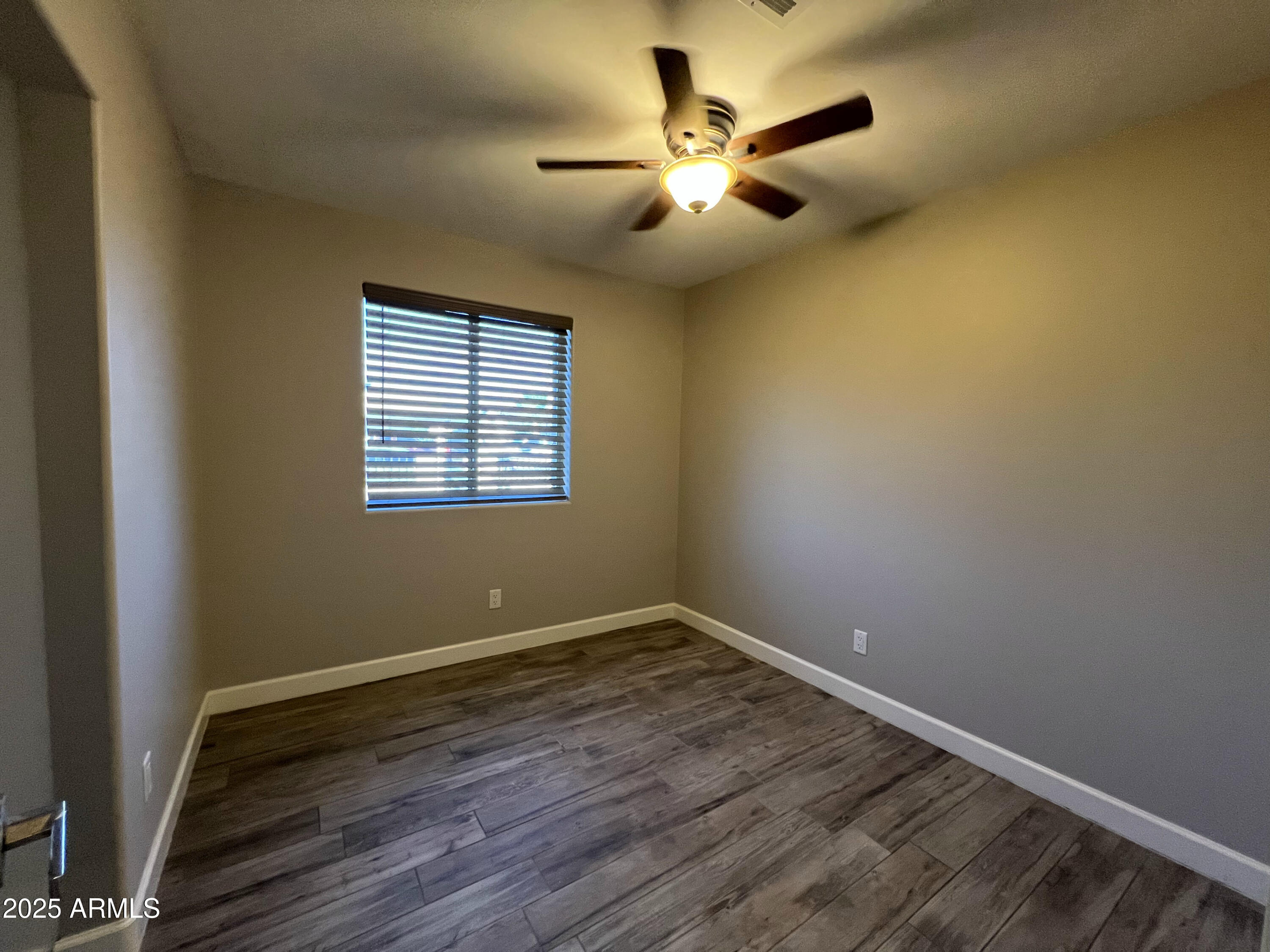 8201 South 26th Street Phoenix, AZ 85042 - Photo 16 of 42 an empty room with wooden floor and windows