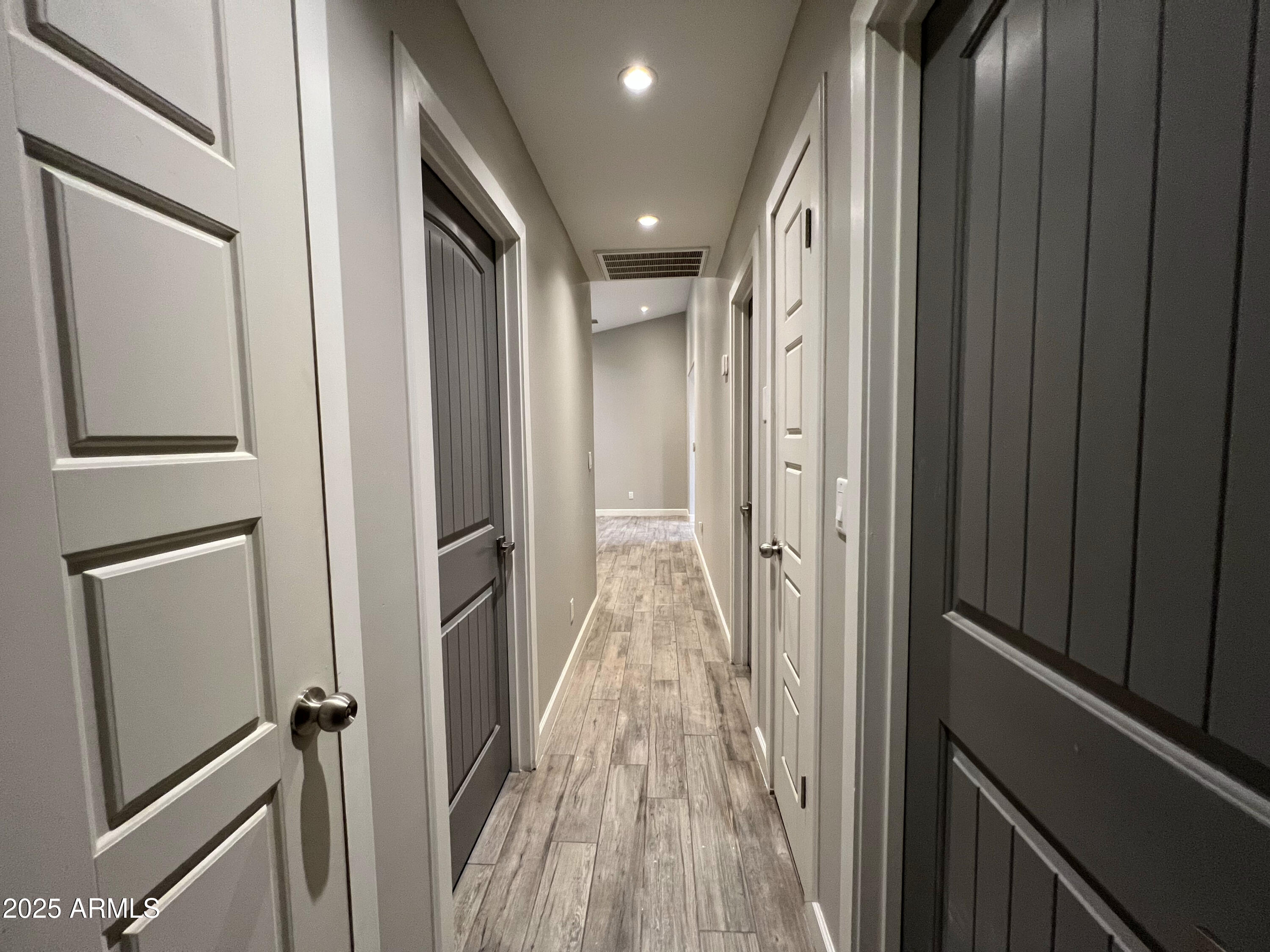 8201 South 26th Street Phoenix, AZ 85042 - Photo 23 of 42 a view of a hallway with wooden floor and staircase