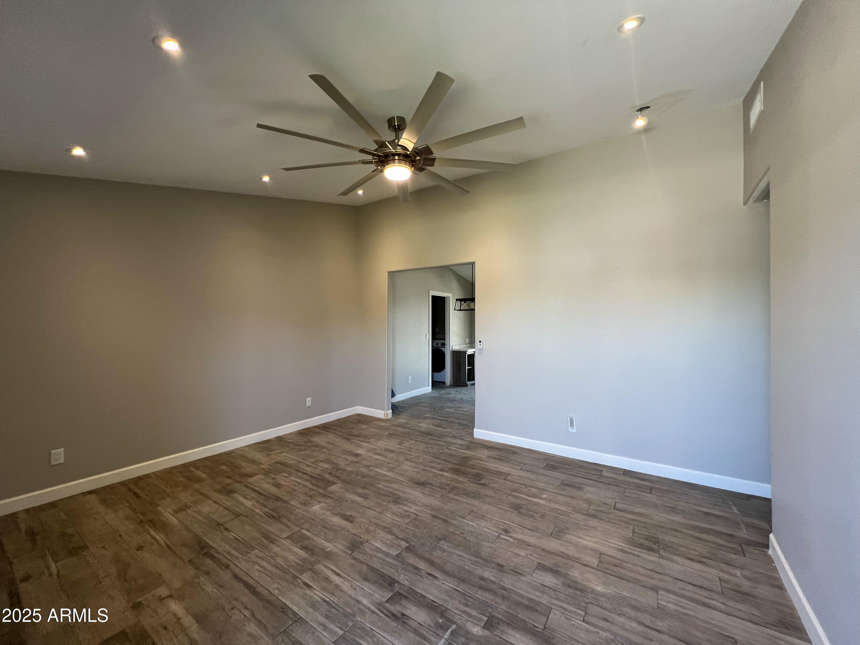8201 South 26th Street Phoenix, AZ 85042 - Photo 3 of 42 an empty room with a ceiling fan and a window