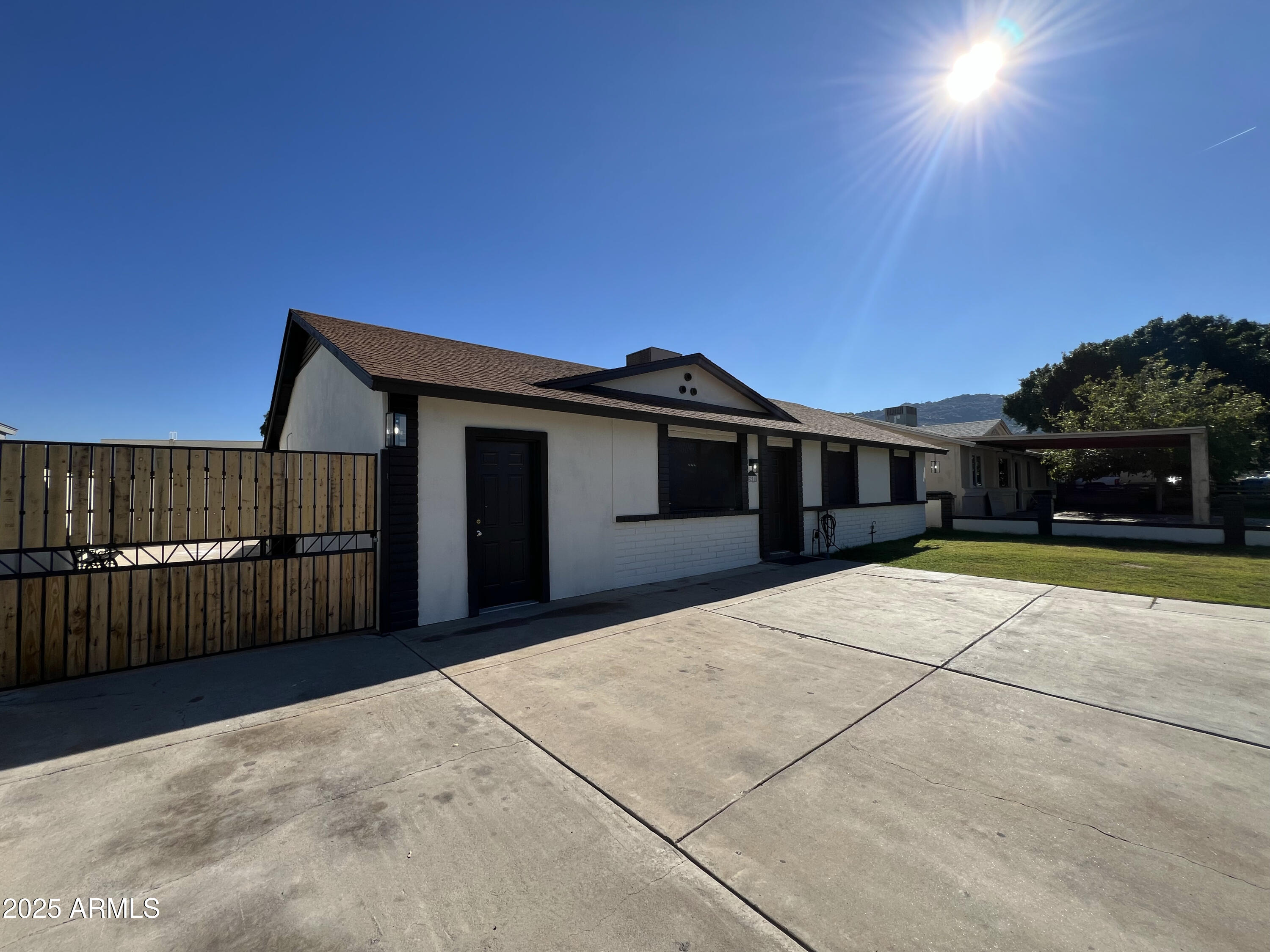 8201 South 26th Street Phoenix, AZ 85042 - Photo 38 of 42 a front view of a house with a yard