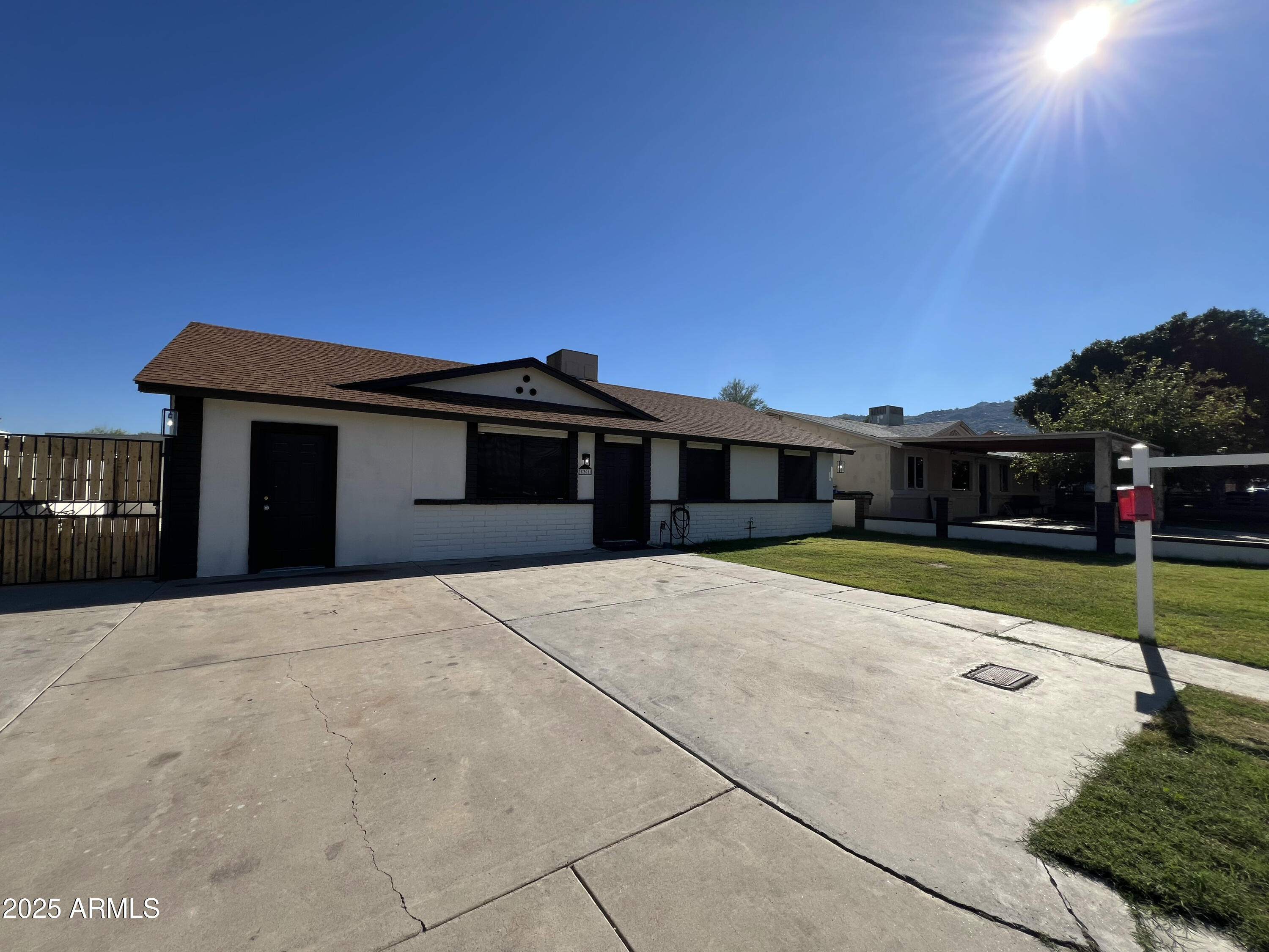 8201 South 26th Street Phoenix, AZ 85042 - Photo 40 of 42 a front view of a house with a yard