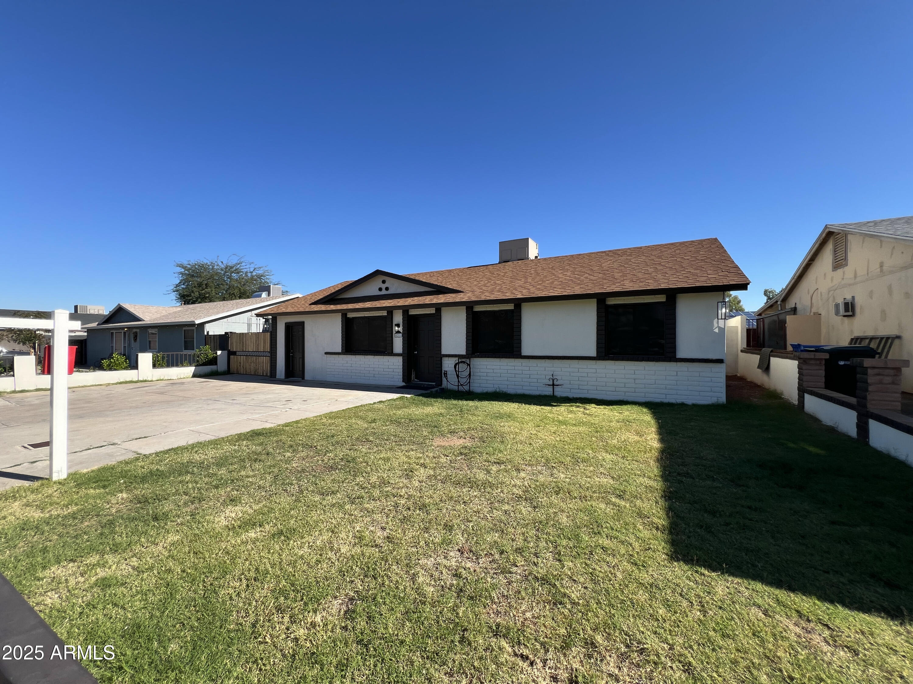 8201 South 26th Street Phoenix, AZ 85042 - Photo 41 of 42 a front view of a house with a garden