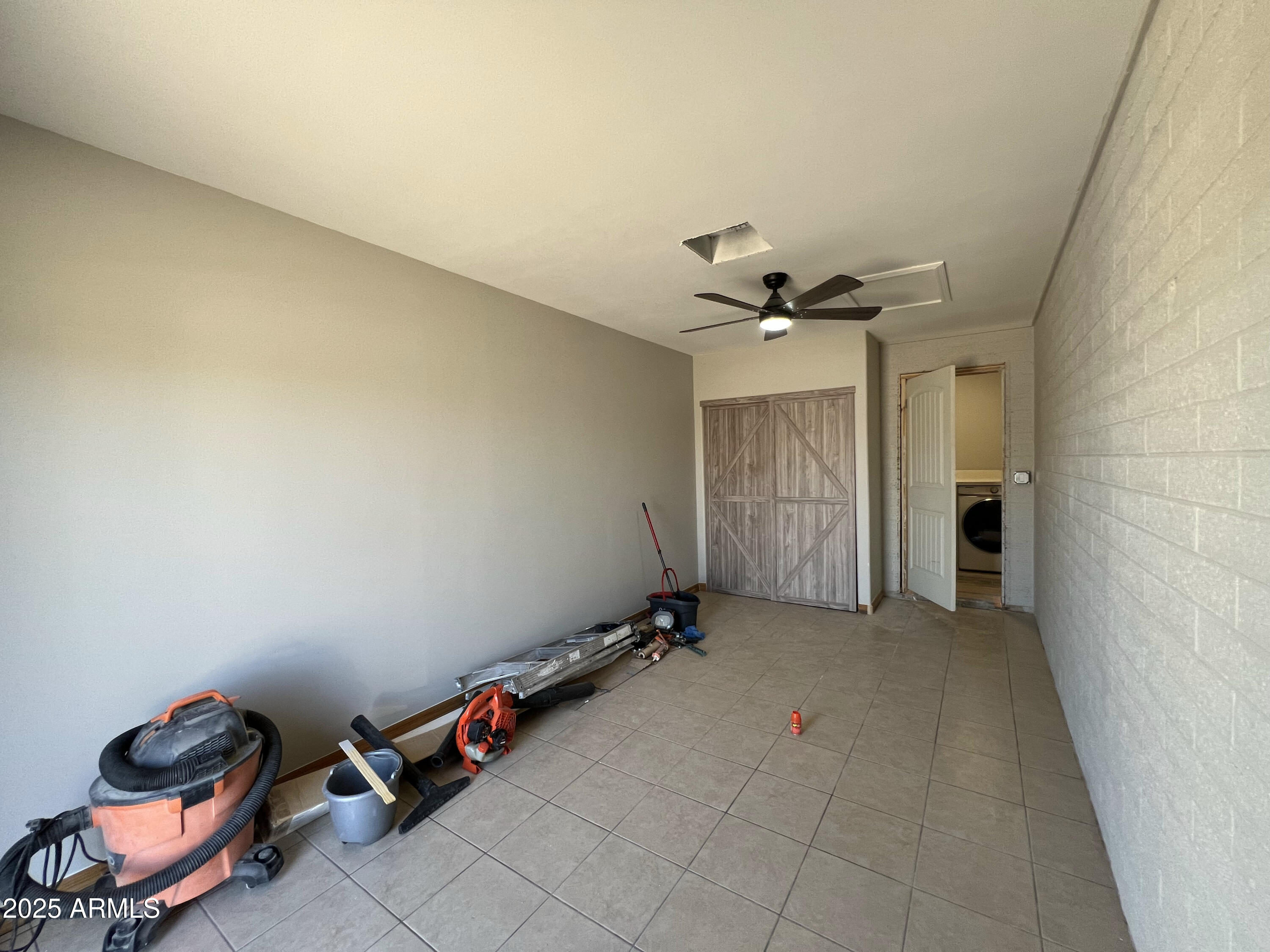 8201 South 26th Street Phoenix, AZ 85042 - Photo 10 of 42 a view of a livingroom with gym equipment and a chandelier