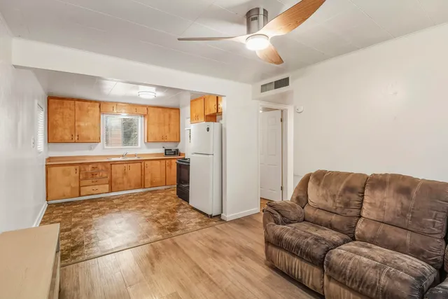 a living room with a couch and a kitchen