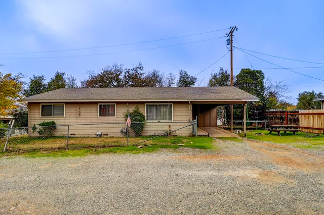 a view of a house with a yard and sitting area