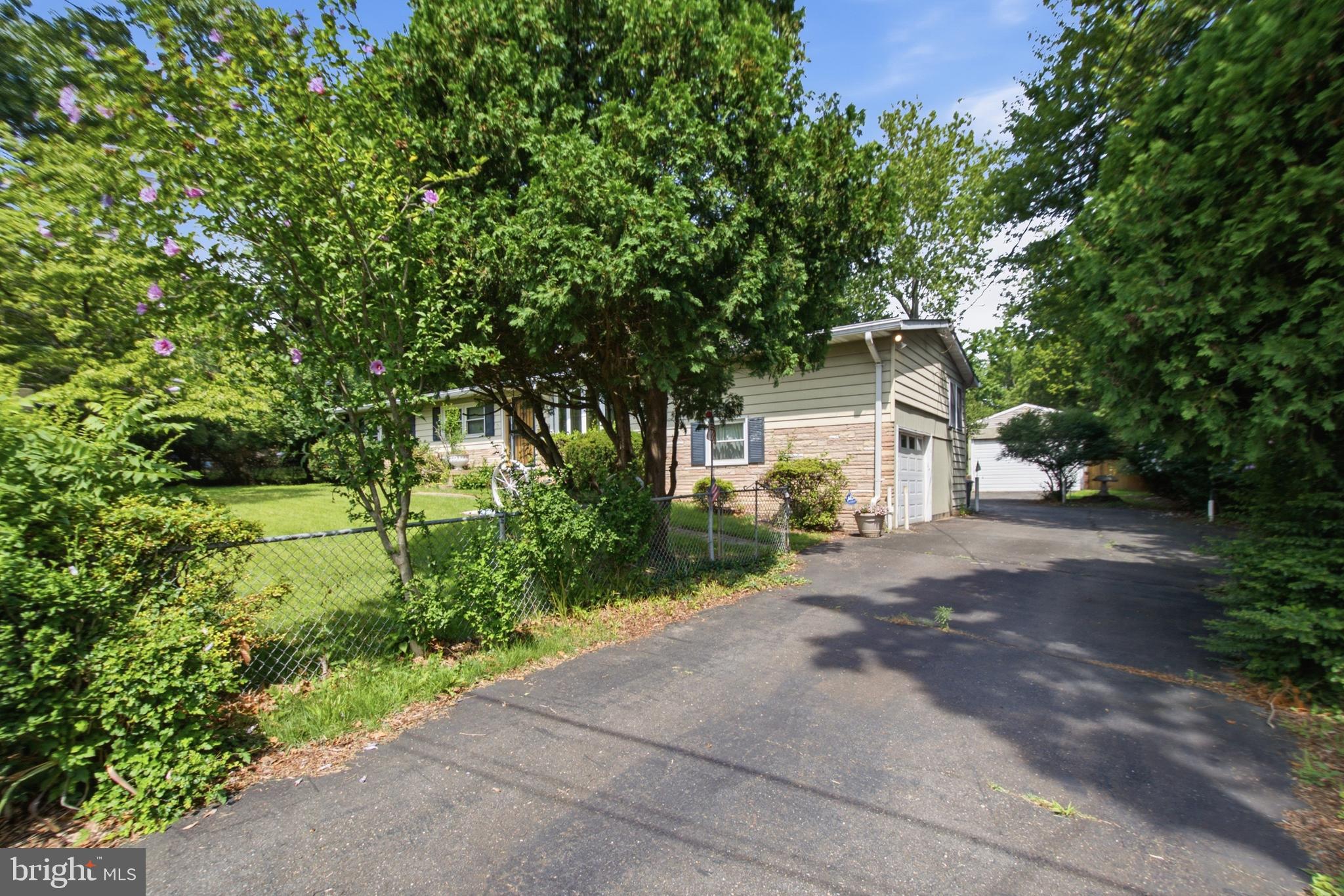 511 Malcolm Road Northwest Vienna, VA 22180 - Photo 2 of 16 a front view of a house with a yard and a garage