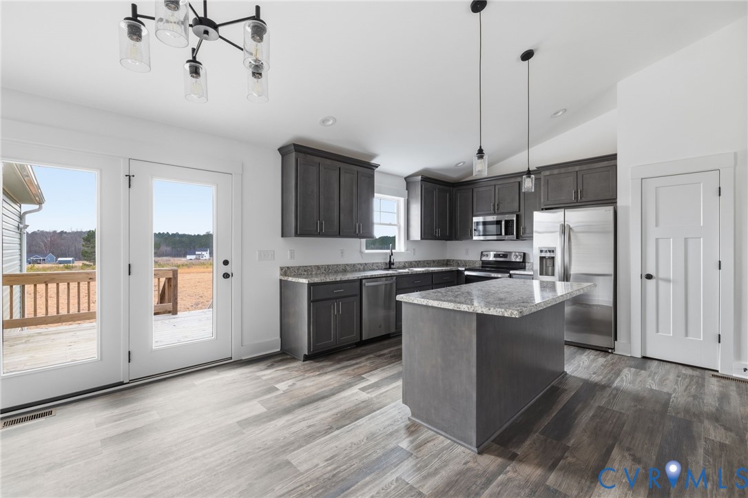 5245 Courtland Road Disputanta, VA 23842 - Photo 8 of 27 a kitchen with stainless steel appliances granite countertop a sink a stove and a refrigerator