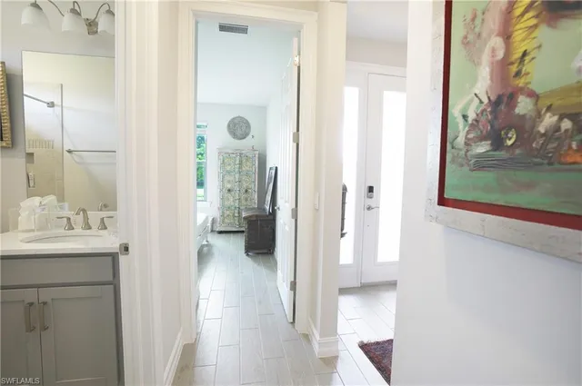 a view of a bathroom from a hallway