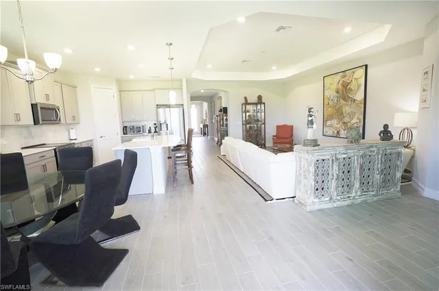 a living room with furniture wooden floor and a chandelier
