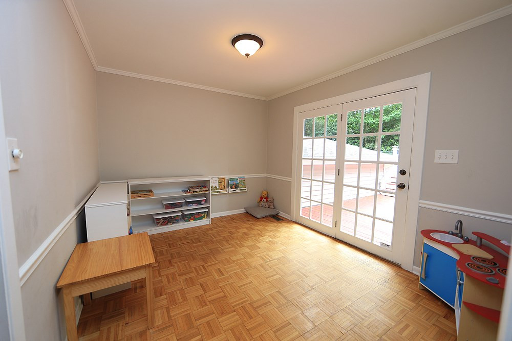 6004 Spring Valley Drive Raleigh, NC 27616 - Photo 7 of 25 This room could have many uses, a den, children's play area, or another home office. Doors lead to deck. Den