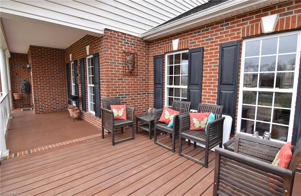 704 Number Ten Way Oak Ridge, NC 27310 - Photo 2 of 30 A wonderful rocking chair front porch is an ideal place to relax and entertain.