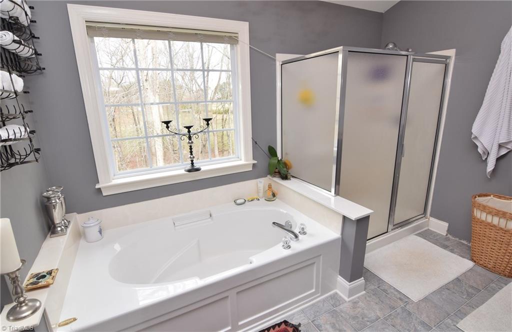 704 Number Ten Way Oak Ridge, NC 27310 - Photo 16 of 30 Spa-like master bath with extra large garden soaking tub and walk-in separate shower.