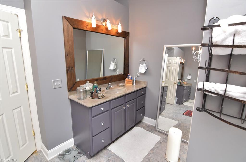 704 Number Ten Way Oak Ridge, NC 27310 - Photo 17 of 30 There are two separate vanity sinks in the master bath. Plenty of storage!