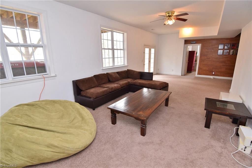 704 Number Ten Way Oak Ridge, NC 27310 - Photo 22 of 30 The lower level has finished and some unfinished space. It is a daylight, walk out basement with a patio beyond.