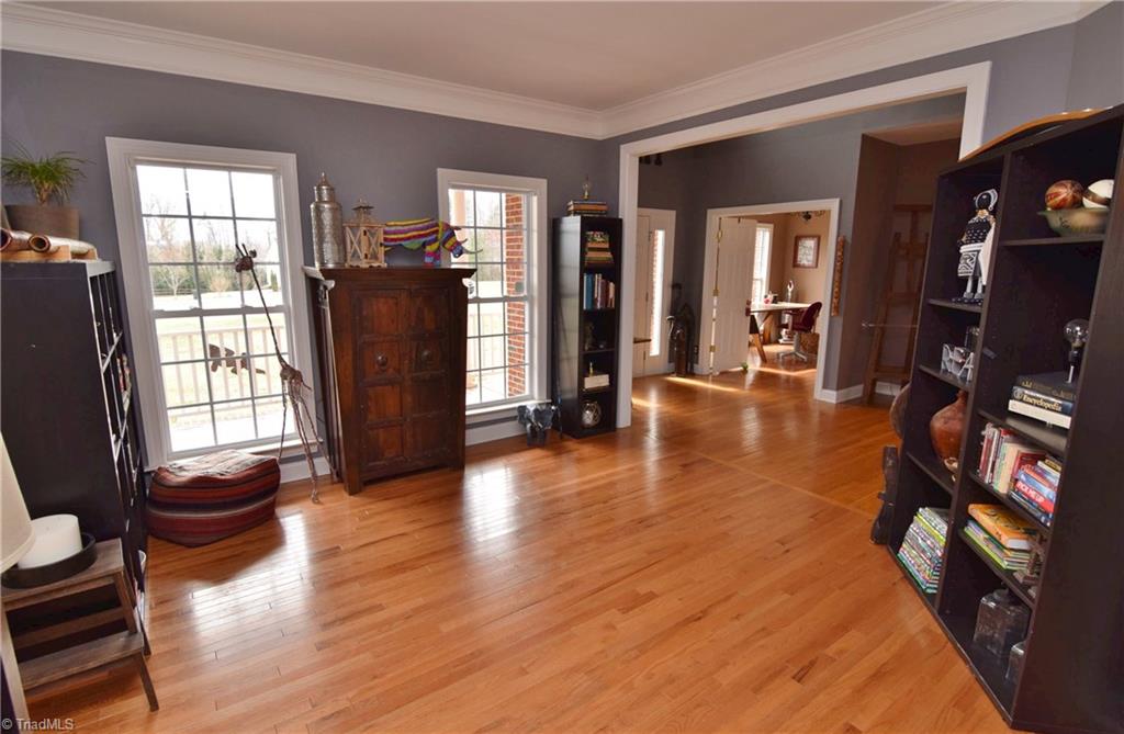 704 Number Ten Way Oak Ridge, NC 27310 - Photo 4 of 30 Formal living room with large windows and heavy crown molding work.