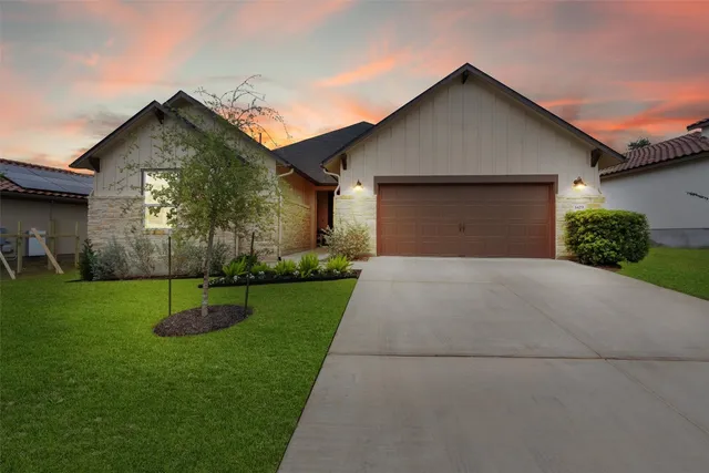 a front view of house with yard and green space
