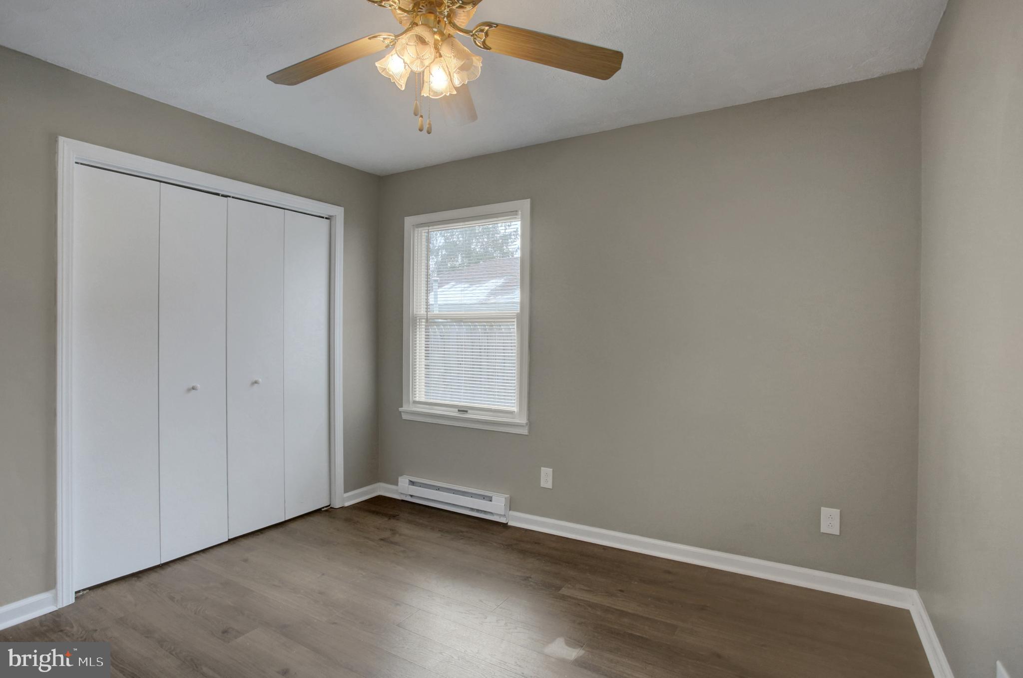 16944 Shinham Road Hagerstown, MD 21740 - Photo 16 of 29 an empty room with wooden floor and windows