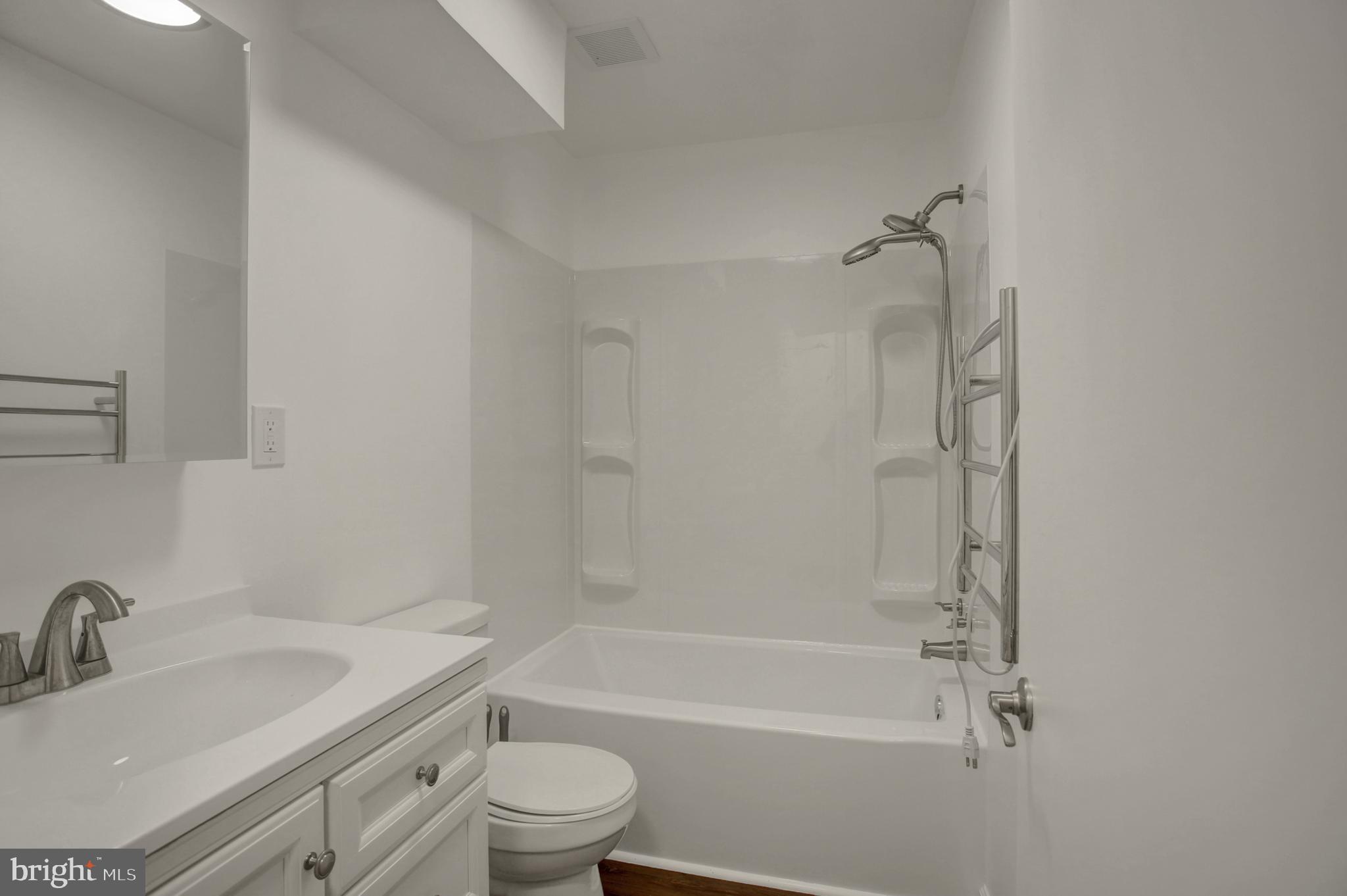 16944 Shinham Road Hagerstown, MD 21740 - Photo 18 of 29 a bathroom with a granite countertop toilet a sink and a bathtub