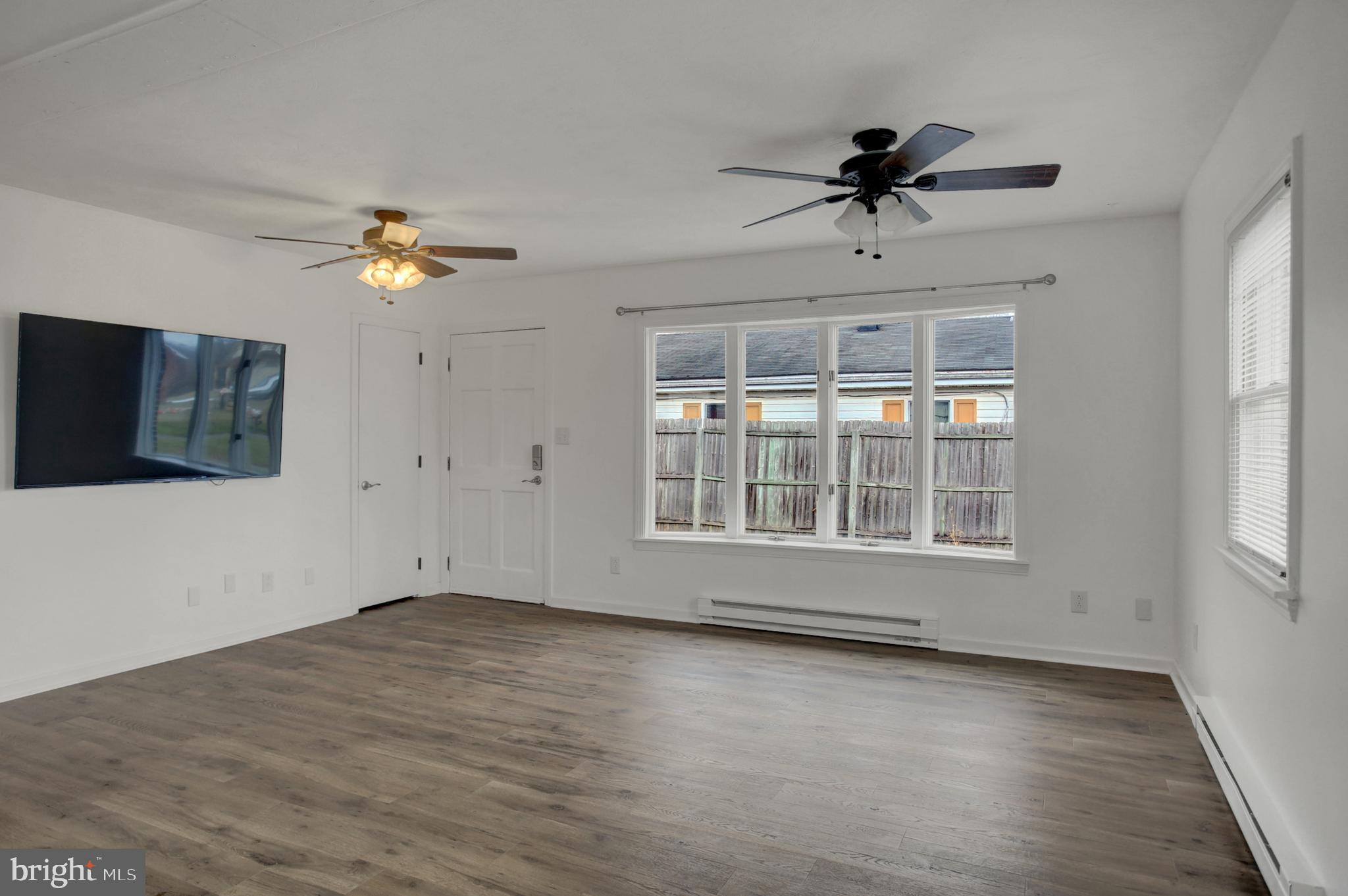 16944 Shinham Road Hagerstown, MD 21740 - Photo 2 of 29 a view of an empty room with a window and wooden floor
