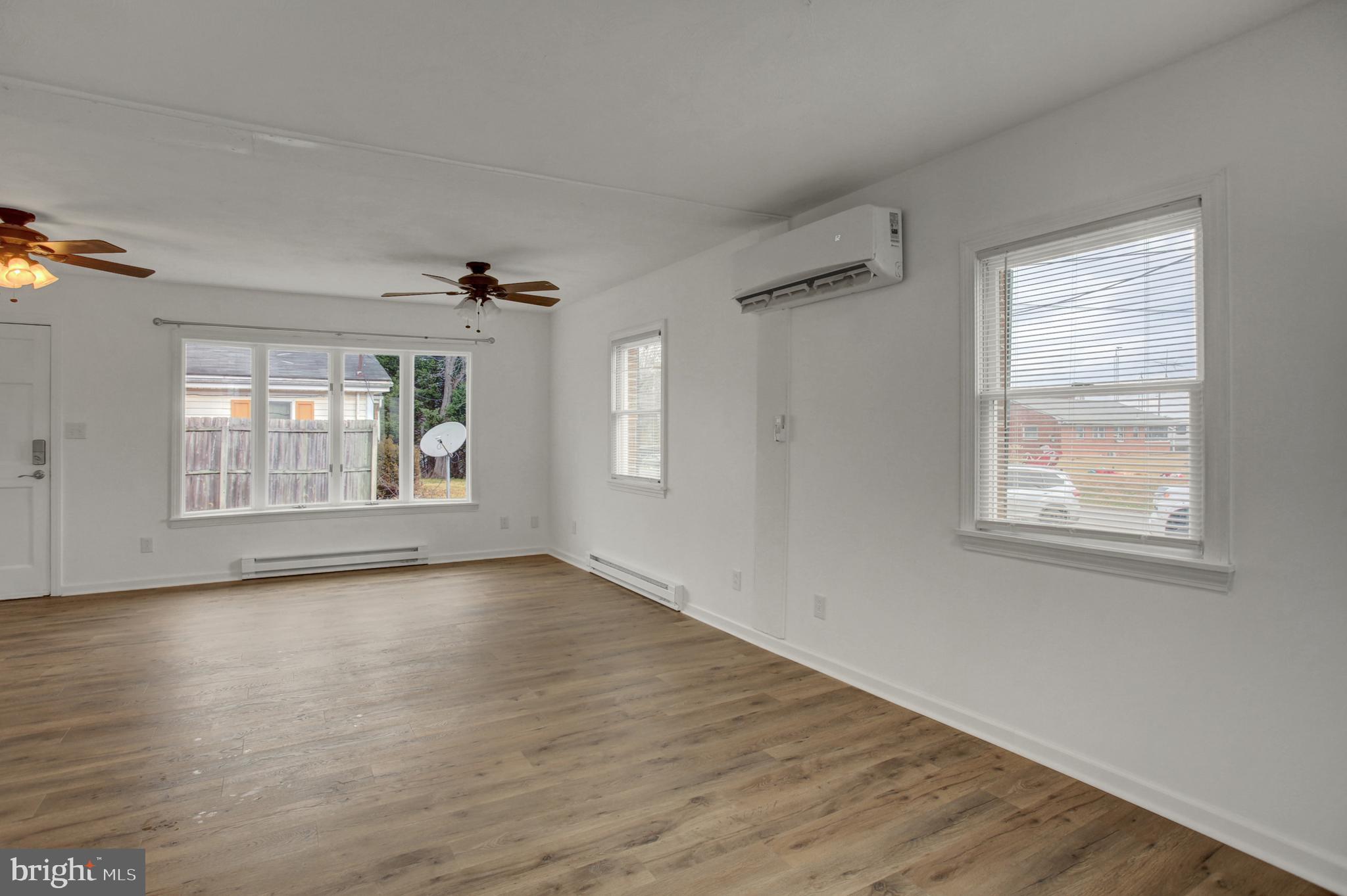 16944 Shinham Road Hagerstown, MD 21740 - Photo 8 of 29 a view of an empty room with a window and wooden floor