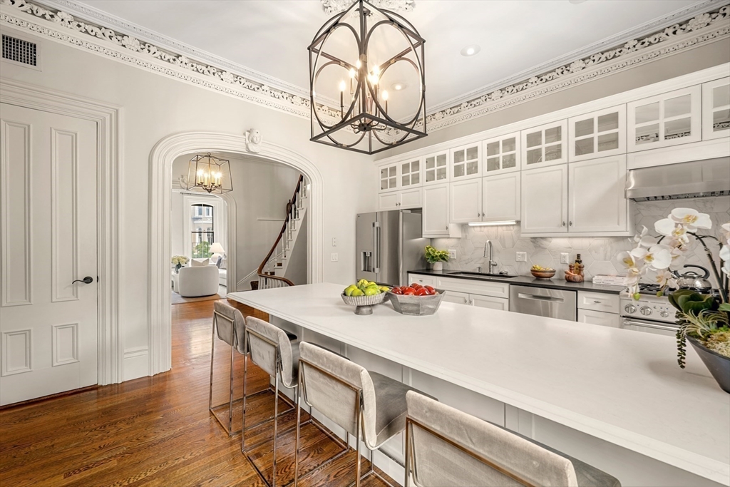22 Rutland Square, Unit 2 Boston, MA 02118 - Photo 11 of 42 a kitchen with a table a stove and cabinets