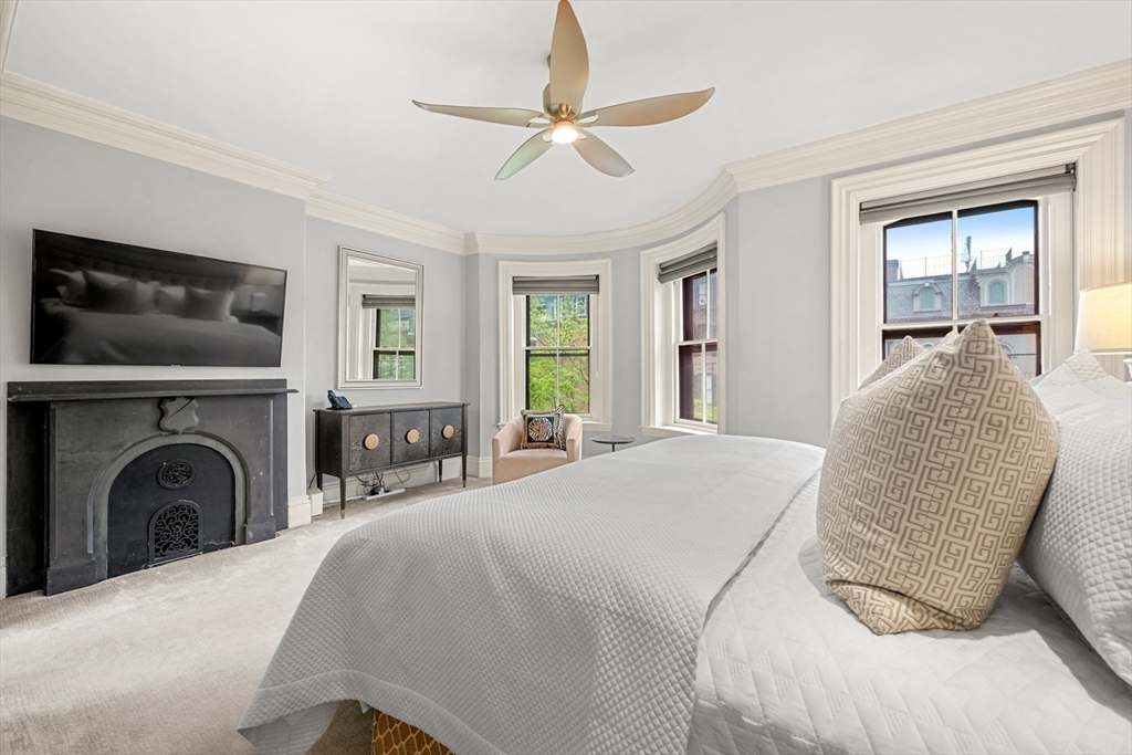 22 Rutland Square, Unit 2 Boston, MA 02118 - Photo 19 of 42 a spacious bedroom with a large bed and a flat screen tv