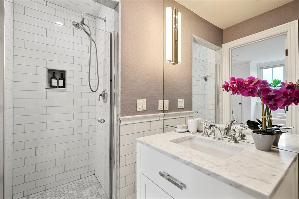 22 Rutland Square, Unit 2 Boston, MA 02118 - Photo 35 of 42 a bathroom with a granite countertop sink a mirror and shower
