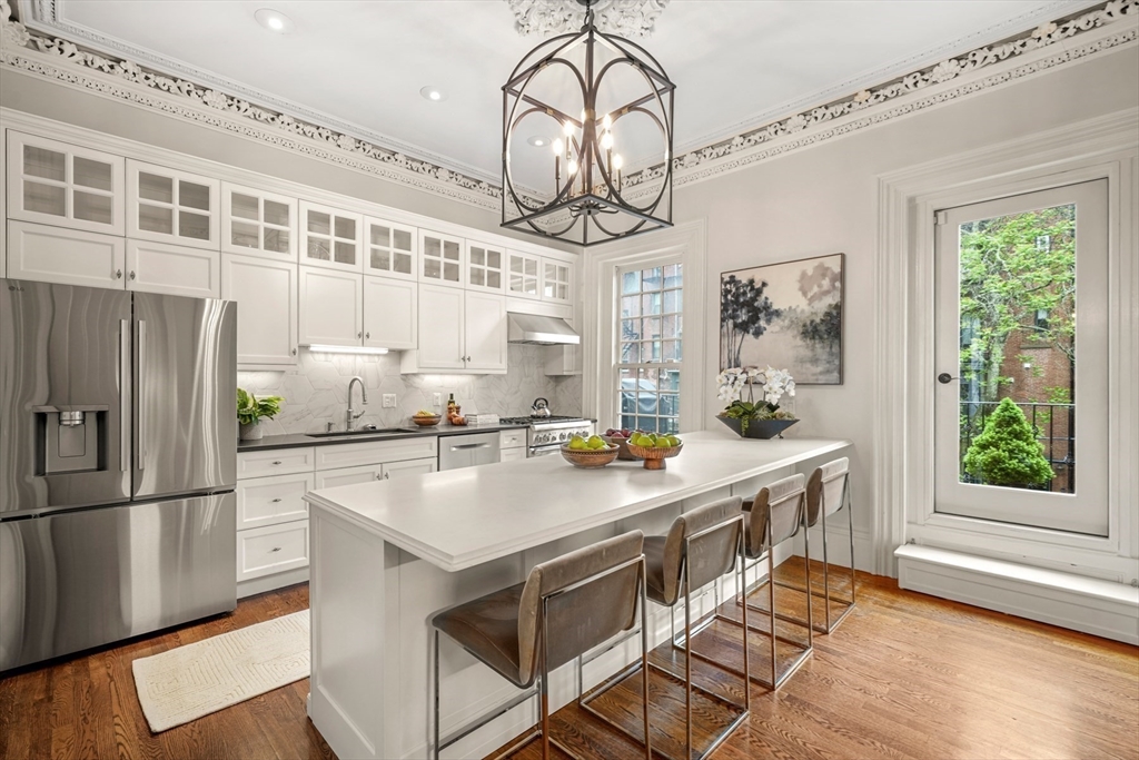 22 Rutland Square, Unit 2 Boston, MA 02118 - Photo 6 of 42 a kitchen with kitchen island a counter space a sink appliances and cabinets