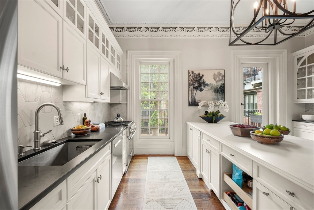 22 Rutland Square, Unit 2 Boston, MA 02118 - Photo 8 of 42 a kitchen with stainless steel appliances a sink a stove and cabinets