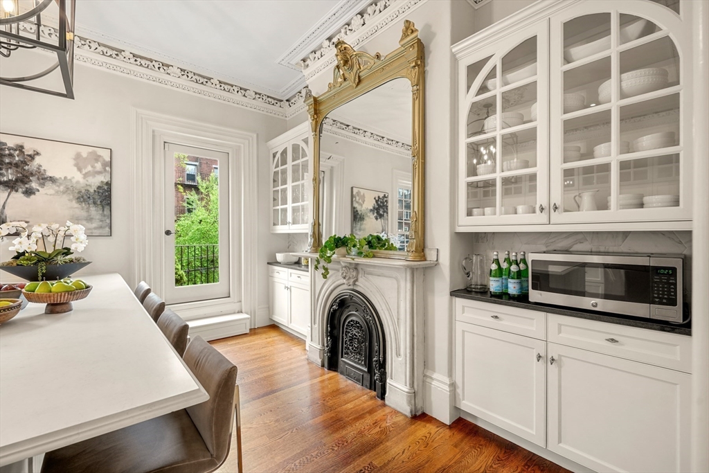 22 Rutland Square, Unit 2 Boston, MA 02118 - Photo 10 of 42 a living room with furniture a fireplace and a floor to ceiling window