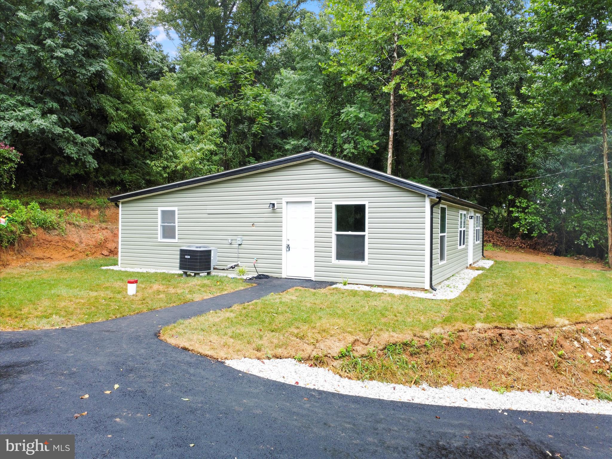 1712 Shenandoah River Drive Harpers Ferry, WV 25425 - Photo 5 of 25 a view of a house with pool and a yard