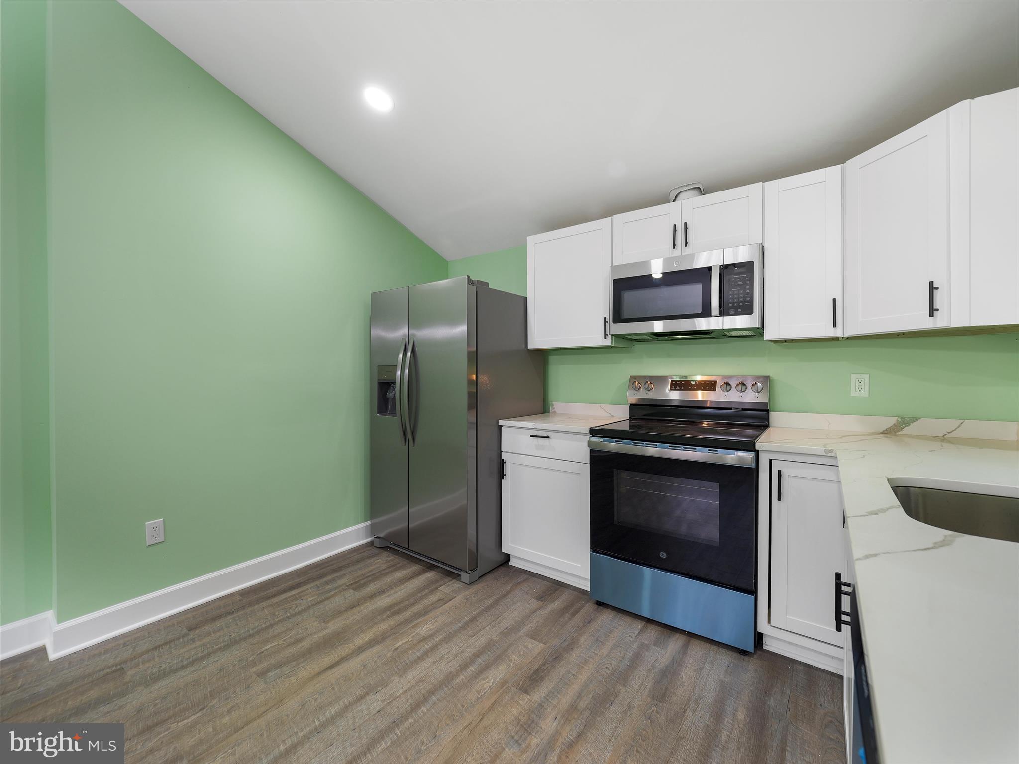 1712 Shenandoah River Drive Harpers Ferry, WV 25425 - Photo 7 of 25 a kitchen with stainless steel appliances a stove a microwave and sink
