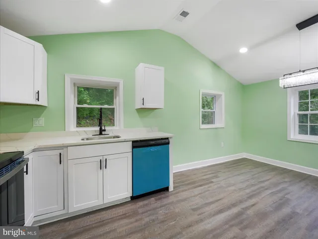 a kitchen with sink and cabinets