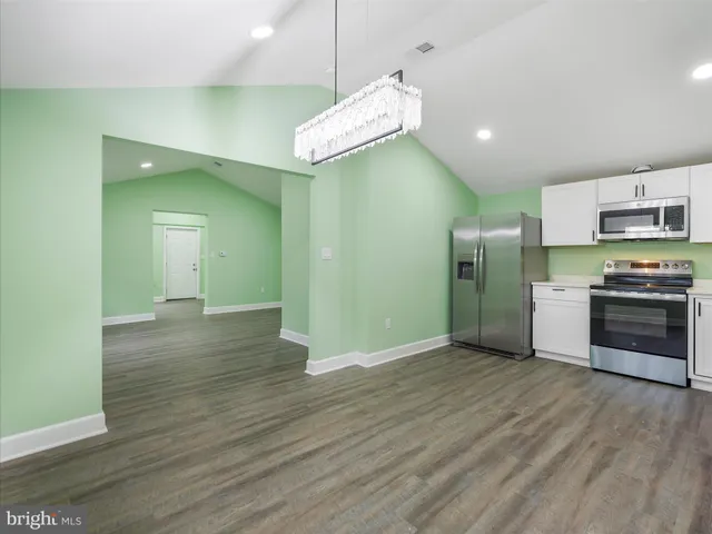 a view of a kitchen with a sink and a stove top oven