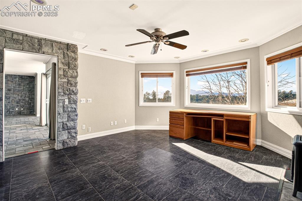13950 Herring Road Colorado Springs, CO 80908 - Photo 11 of 50 a view of an empty room with a window and kitchen view